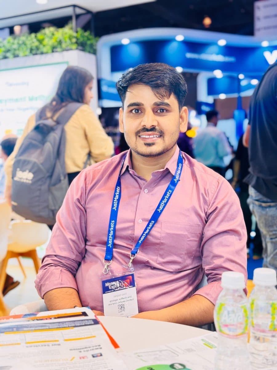 Ranjeet Saini seated at a meeting table at an industry expo