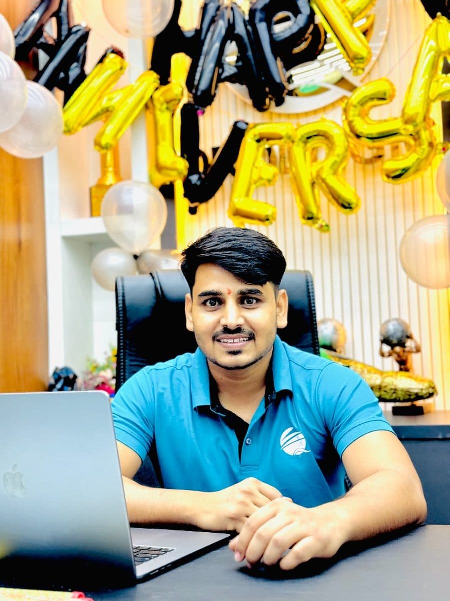 Ranjeet Saini at his desk in the Qrologic office during a team celebration