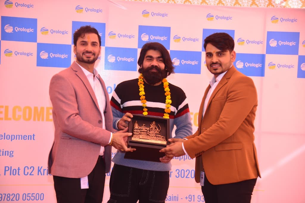 Ranjeet Saini presenting an award at the Qrologic office opening
